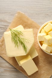 Tasty butter with dill on wooden table, top view