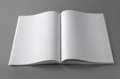 Open blank brochure on light grey background