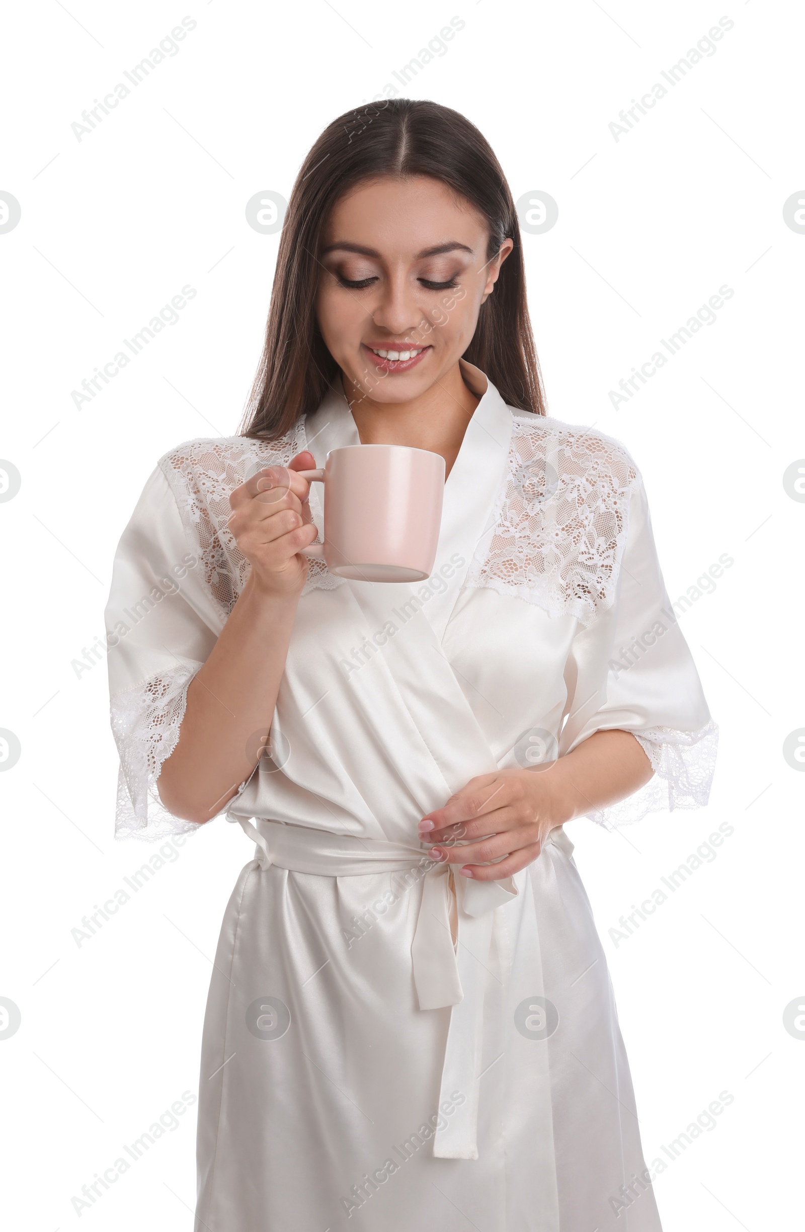 Photo of Young woman in silk robe with cup of beverage on white background