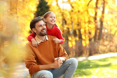 Photo of Happy father and daughter spending time in park. Autumn walk