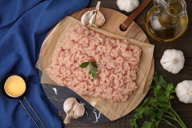 Photo of Flat lay composition with fresh raw minced meat and products on wooden table