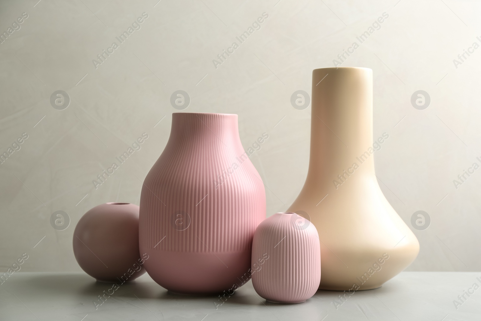 Photo of Stylish ceramic vases on grey stone table