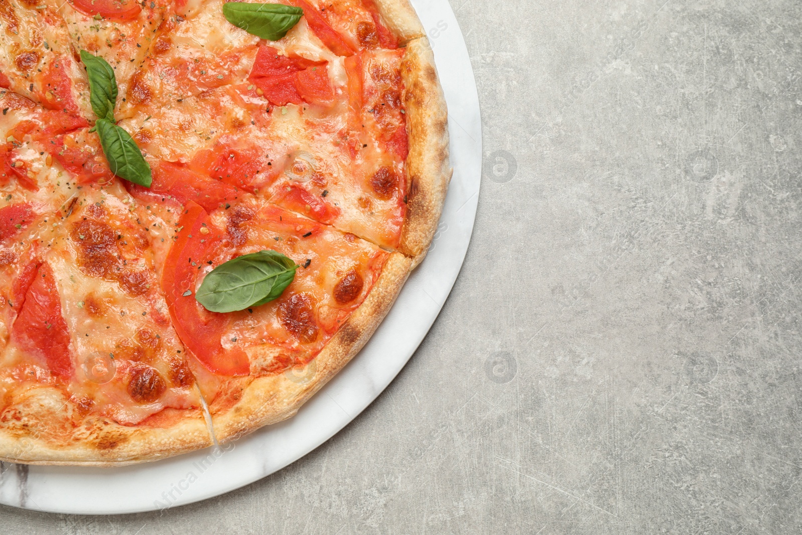 Photo of Delicious pizza Margherita on light grey table, top view. Space for text