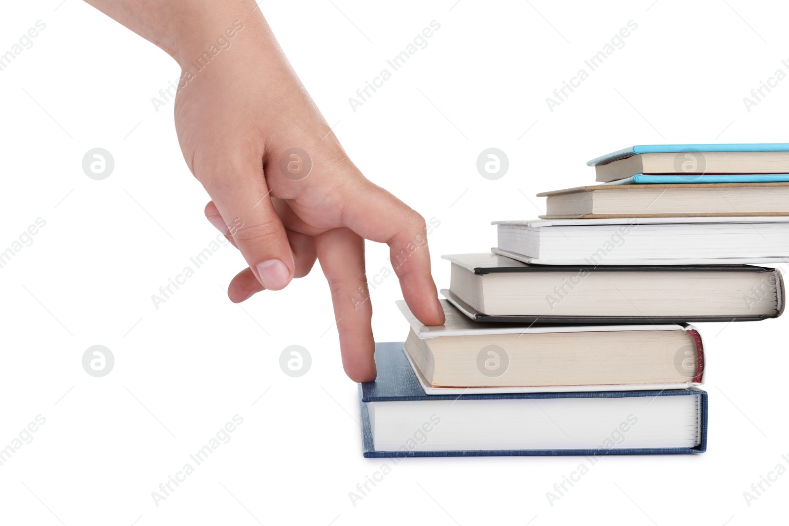 Photo of Woman imitating stepping up on books with her fingers against white background, closeup