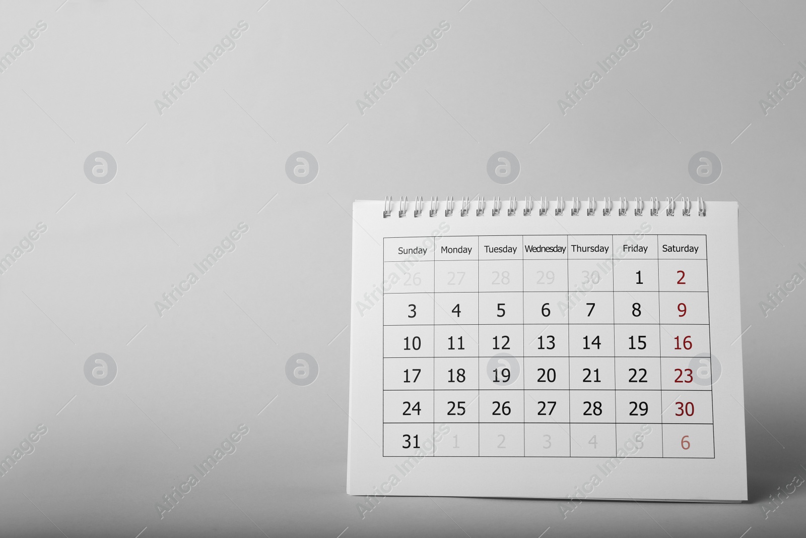 Photo of Paper calendar on grey background, space for text. Planning concept