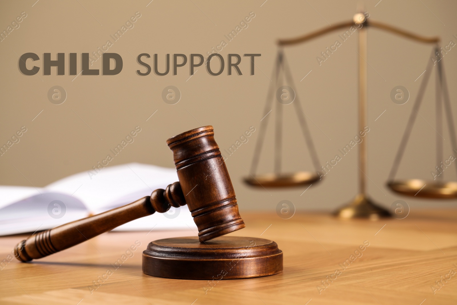 Image of Judge's gavel, scales of justice and book on wooden table. Child support concept