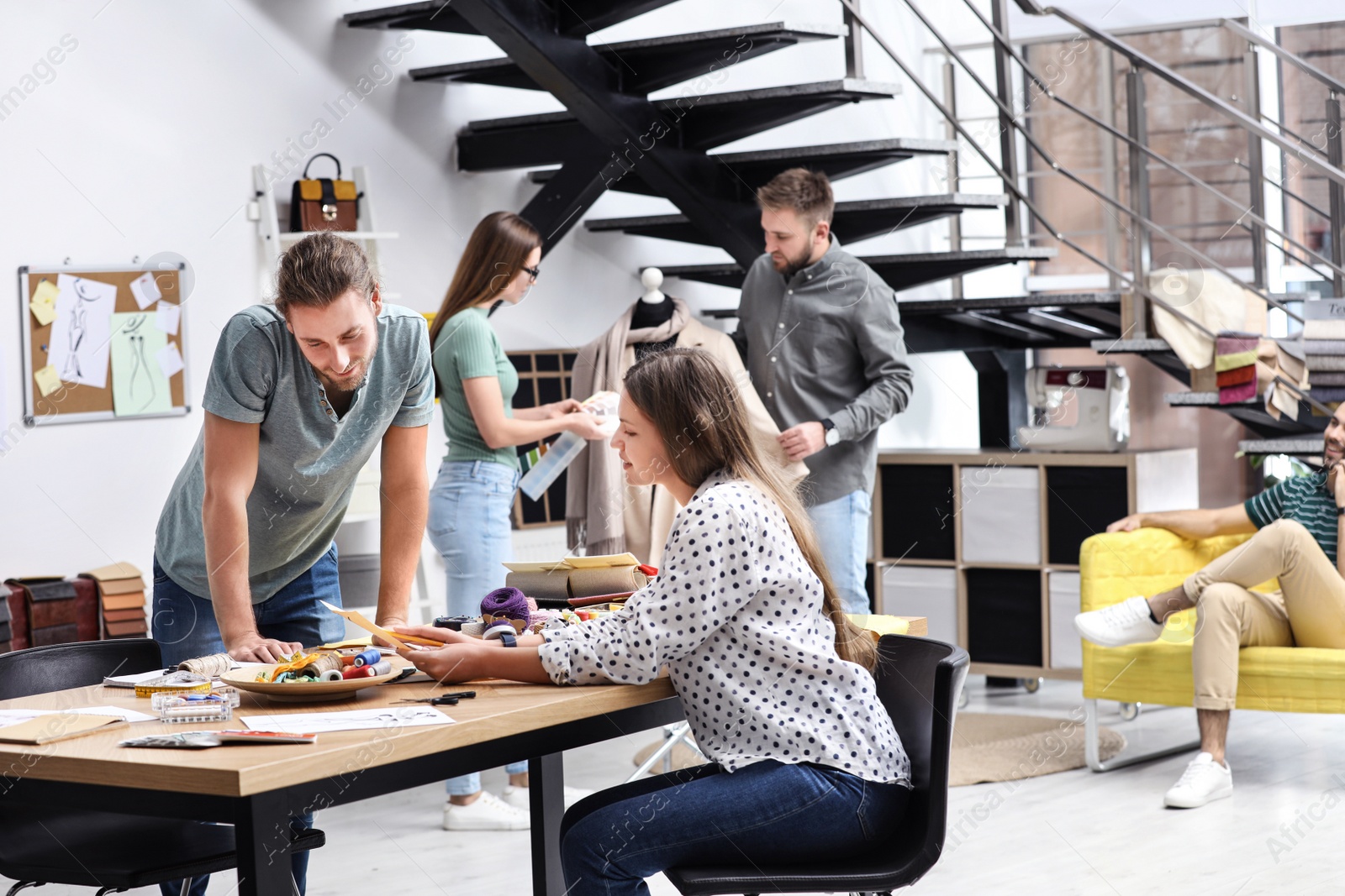 Photo of Fashion designers creating new clothes in studio