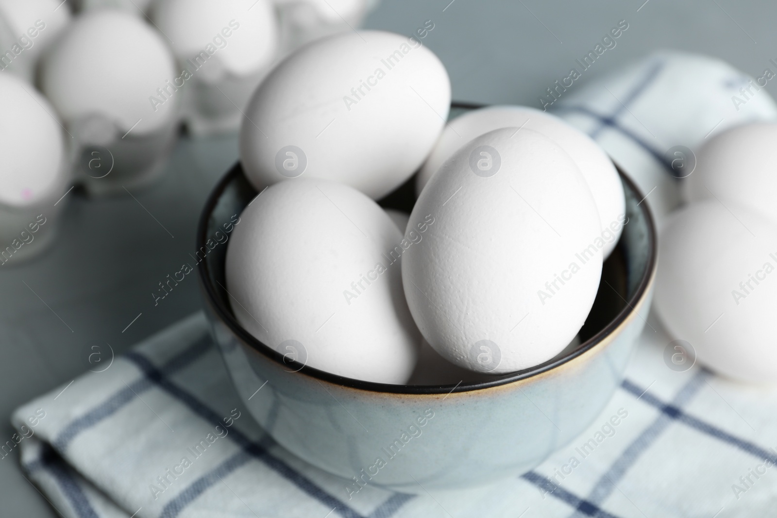 Photo of Chicken eggs in bowl on table, closeup