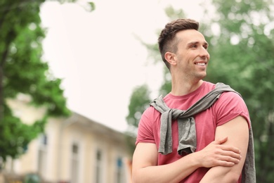 Portrait of attractive young man in stylish outfit outdoors