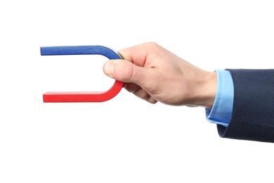 Man holding magnet on white background, closeup