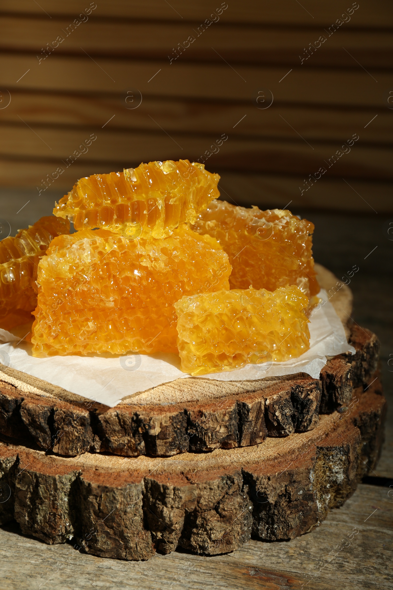 Photo of Natural honeycombs on rustic table, closeup view