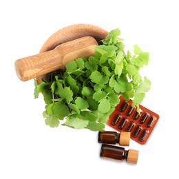 Photo of Mortar with fresh green celandine, extracts and pills on white background, top view