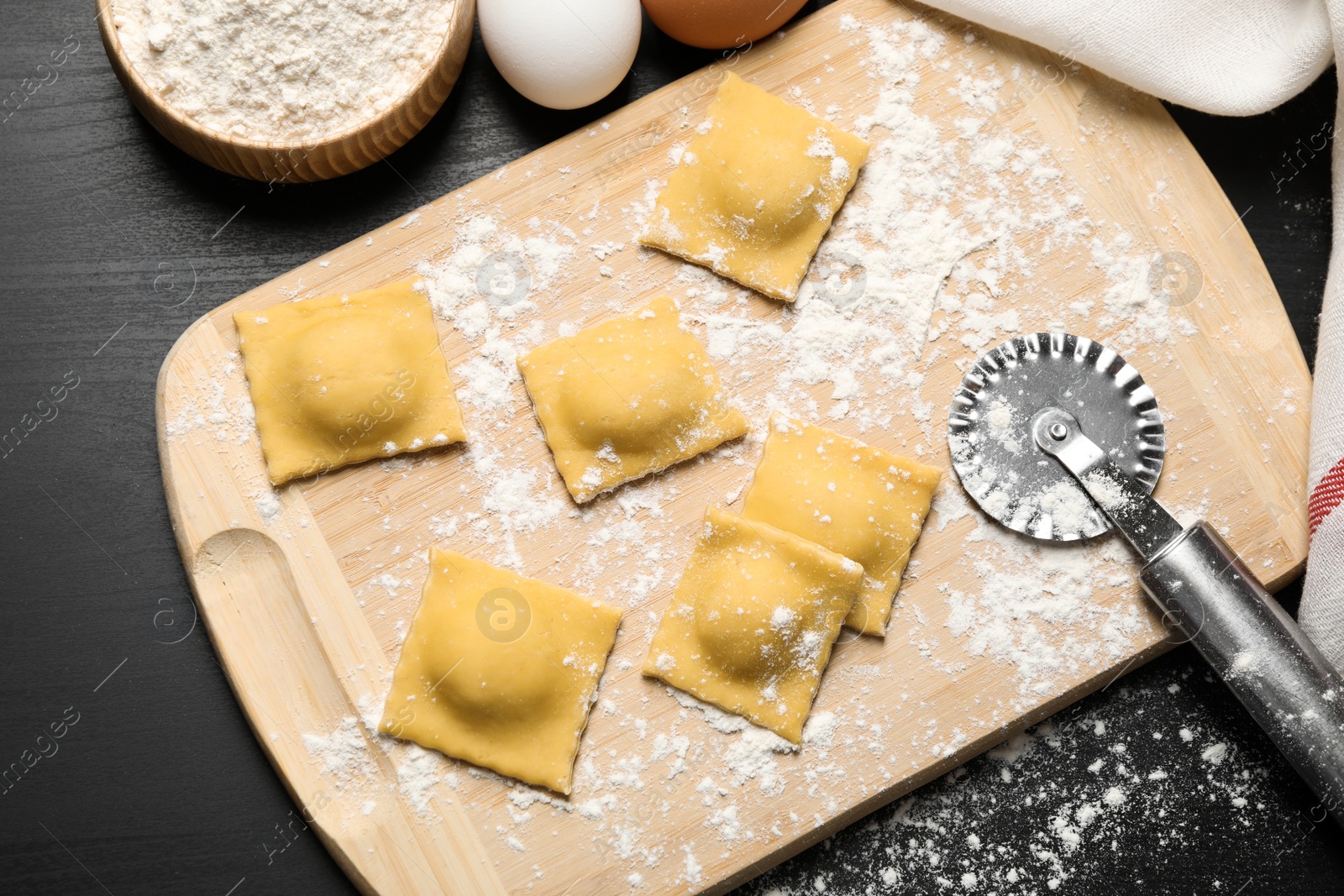 Photo of Flat lay composition with raw ravioli on grey table. Italian pasta