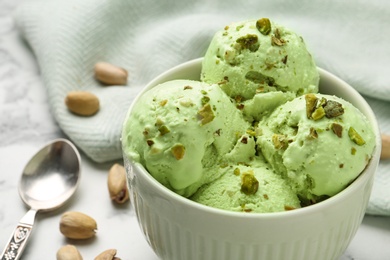Photo of Tasty pistachio ice cream on table, closeup view