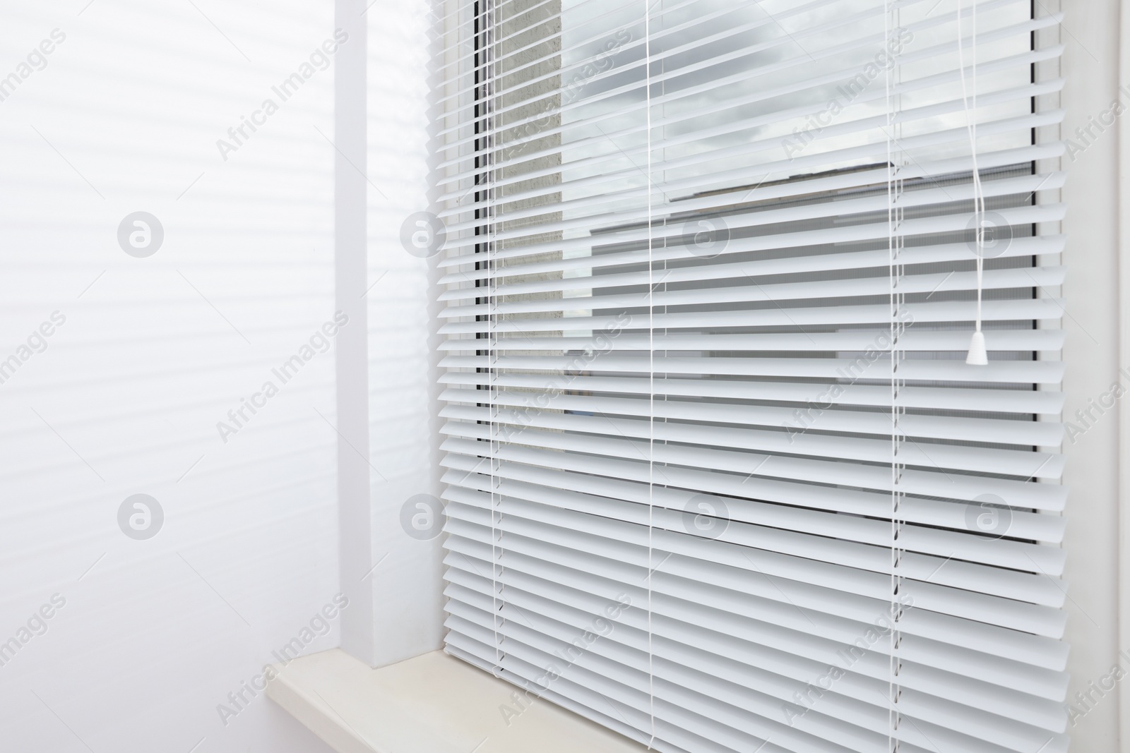 Photo of Stylish window with horizontal blinds in room