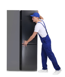 Photo of Professional worker carrying refrigerator on white background