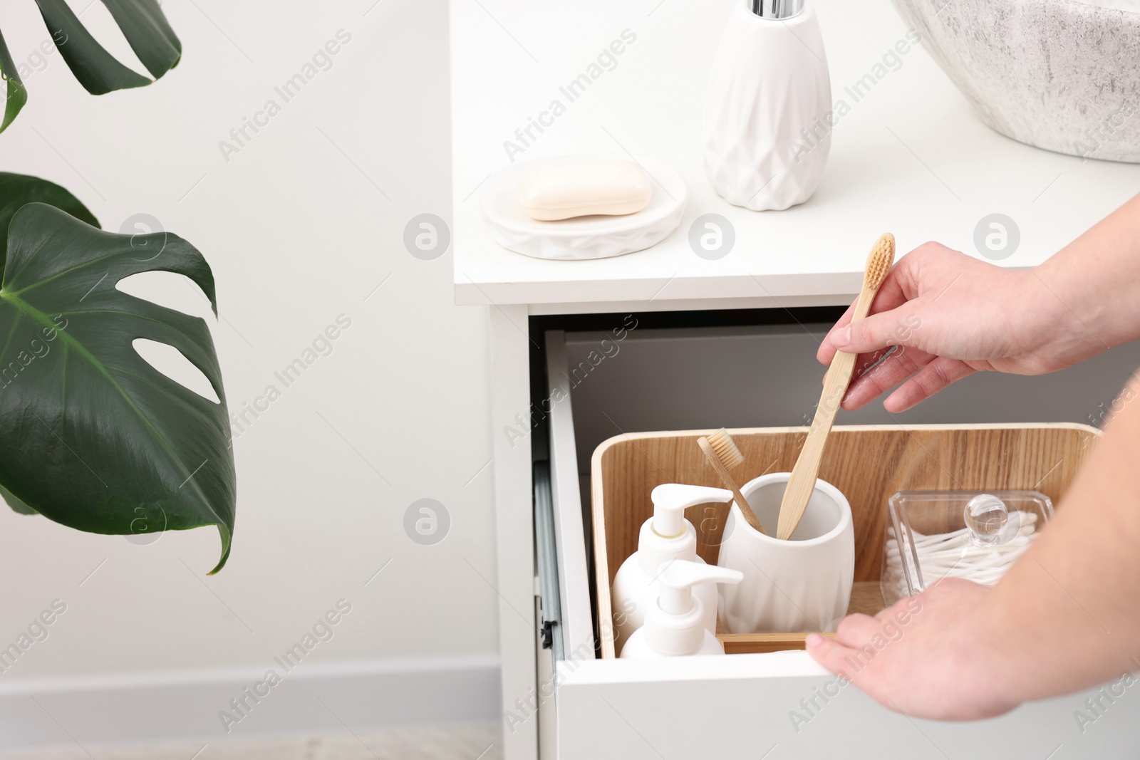 Photo of Bath accessories. Woman with toothbrush indoors, closeup and space for text