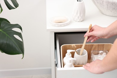 Bath accessories. Woman with toothbrush indoors, closeup and space for text