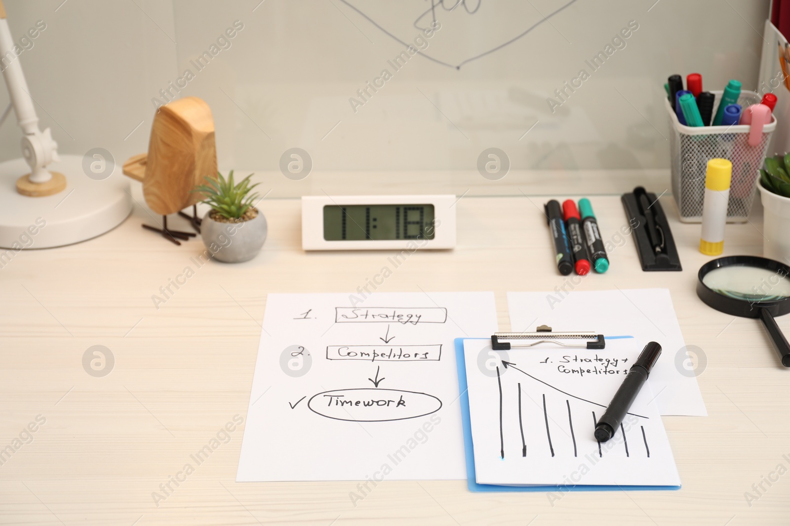 Photo of Business process planning and optimization. Workplace with plan, notebook and stationery on white wooden table