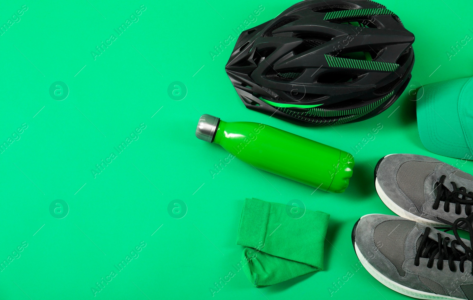 Photo of Different sports equipment on green background, flat lay. Space for text