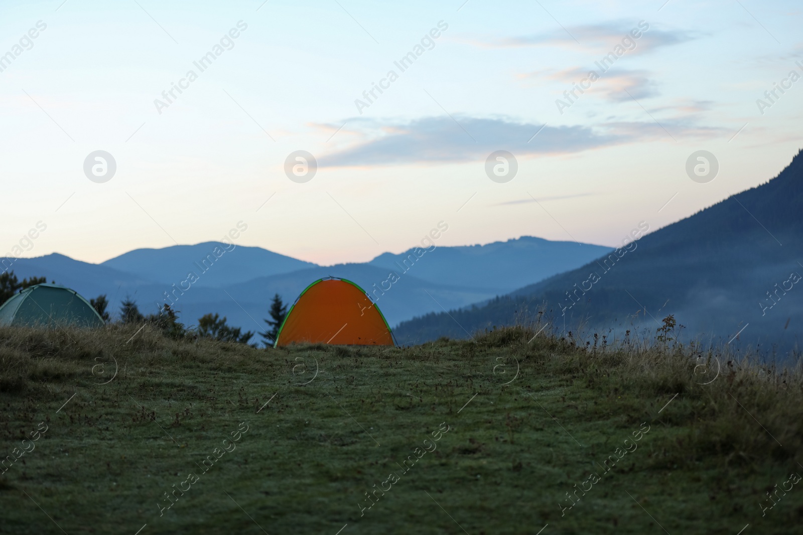 Photo of Camping tents in mountains on early morning