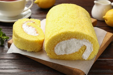 Delicious cake roll on wooden table, closeup