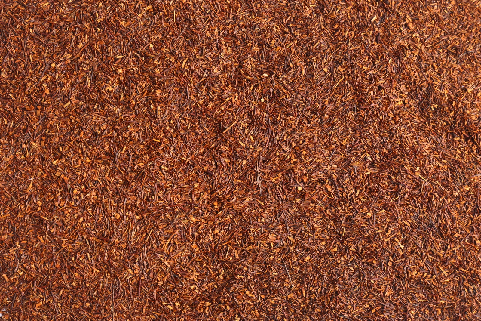 Photo of Heap of dry rooibos tea leaves as background, top view