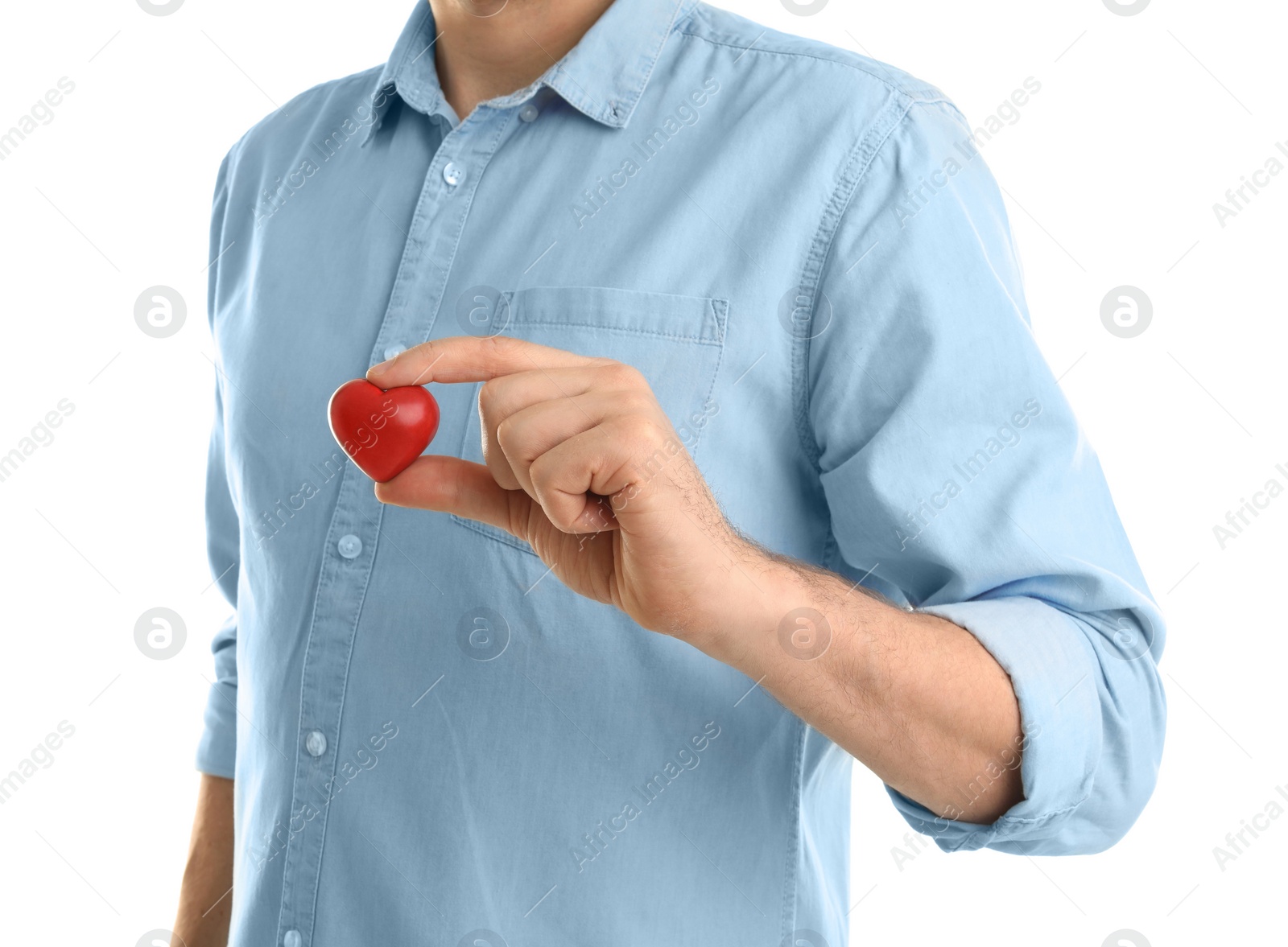 Photo of Man holding small red heart on white background. Heart attack concept