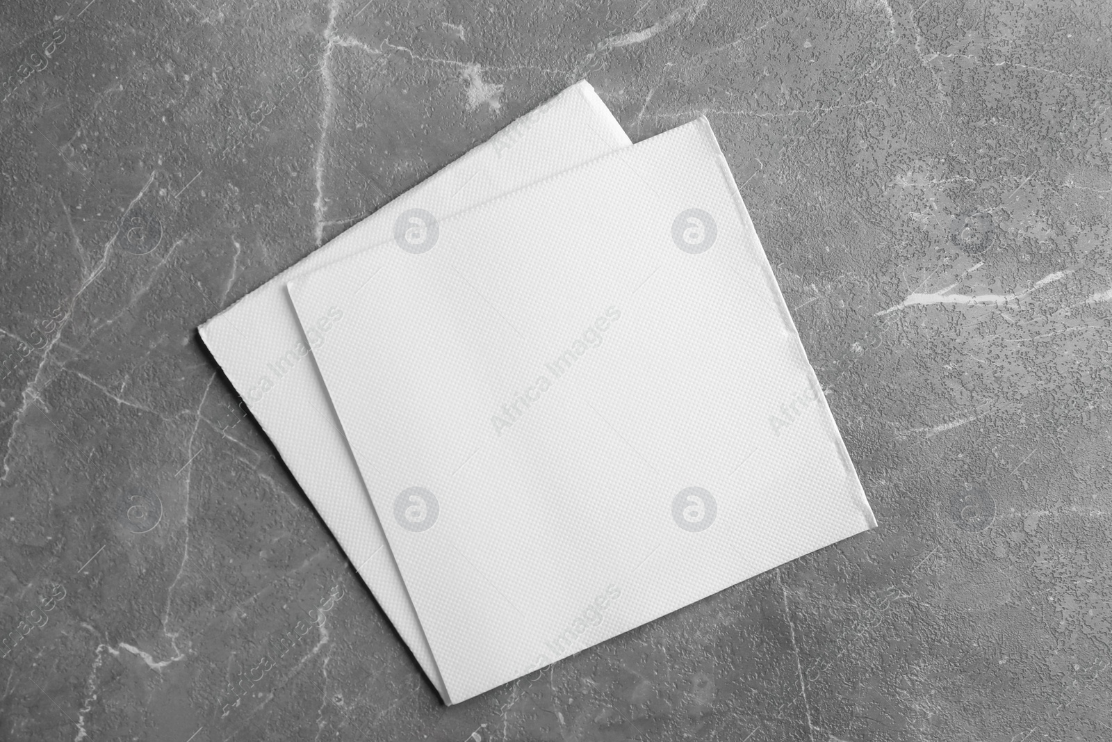 Photo of Clean napkins on marble table, top view