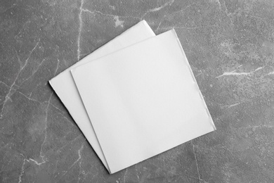 Clean napkins on marble table, top view