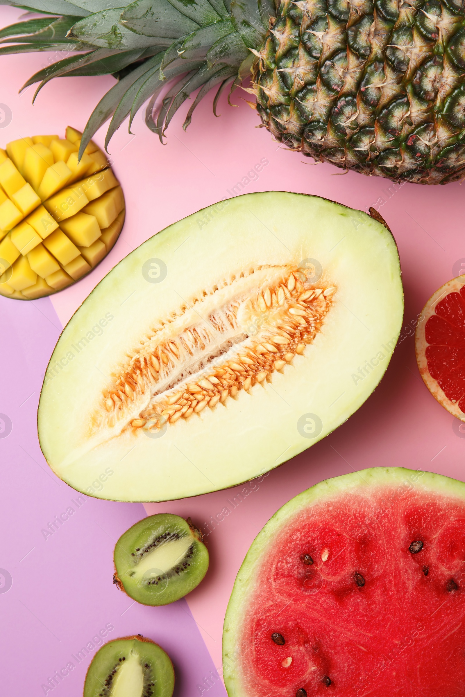 Photo of Flat lay composition with melon and other fruits on color background