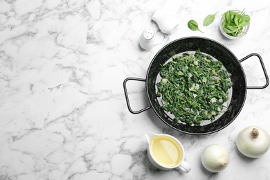 Photo of Flat lay composition with cooked spinach and space for text on white marble table. Healthy food