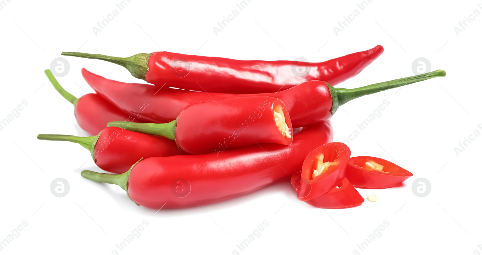 Photo of Cut and whole red hot chili peppers on white background