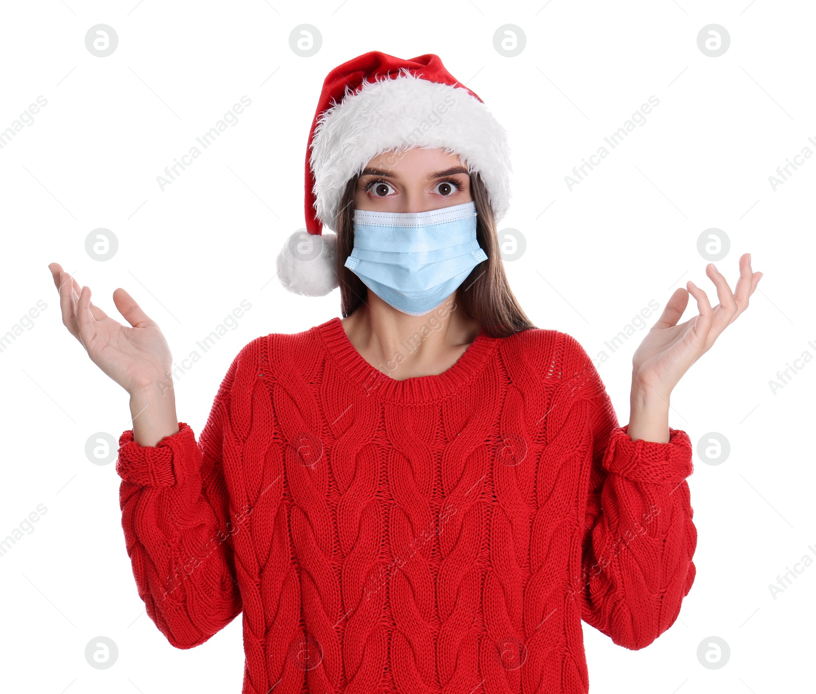 Photo of Shocked woman in Santa hat and medical mask on white background