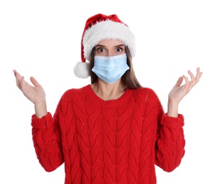 Photo of Shocked woman in Santa hat and medical mask on white background
