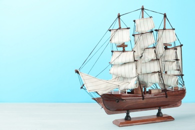 Beautiful ship model on white wooden table. Space for text
