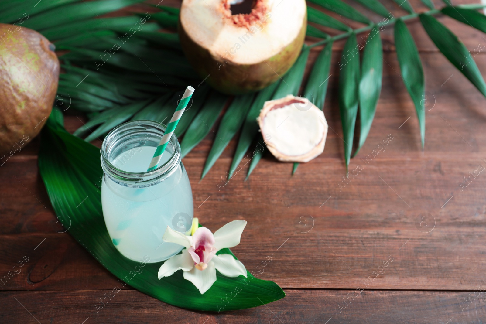 Photo of Beautiful composition with coconut water on wooden table