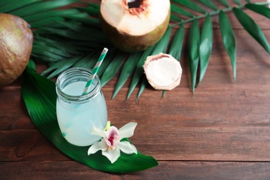 Beautiful composition with coconut water on wooden table