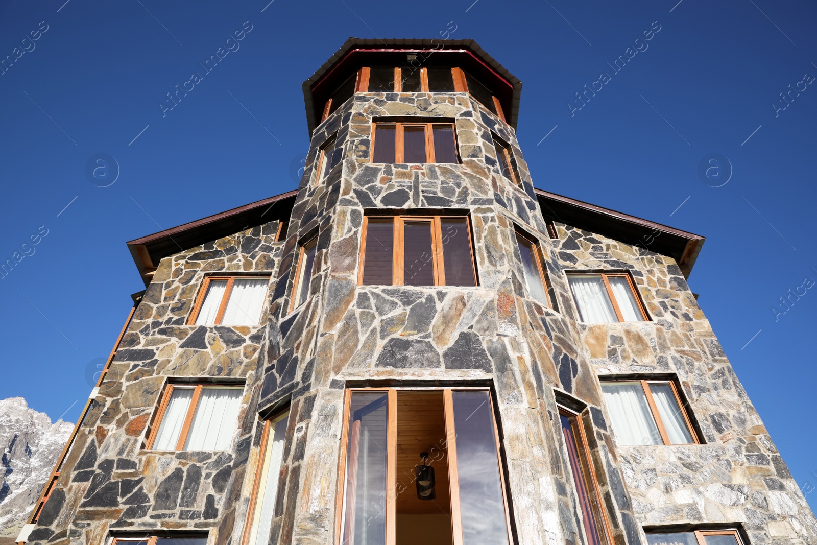 Photo of Exterior of beautiful building with stone fragments against blue sky, low angle view