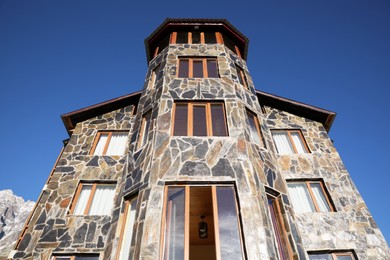 Photo of Exterior of beautiful building with stone fragments against blue sky, low angle view