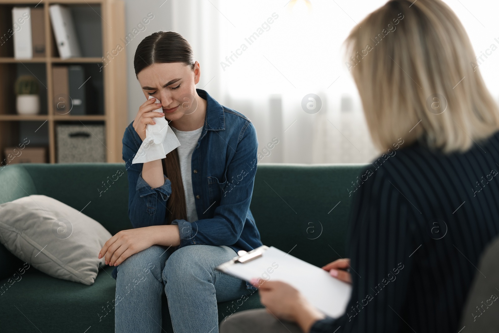 Photo of Professional psychotherapist working with patient in office