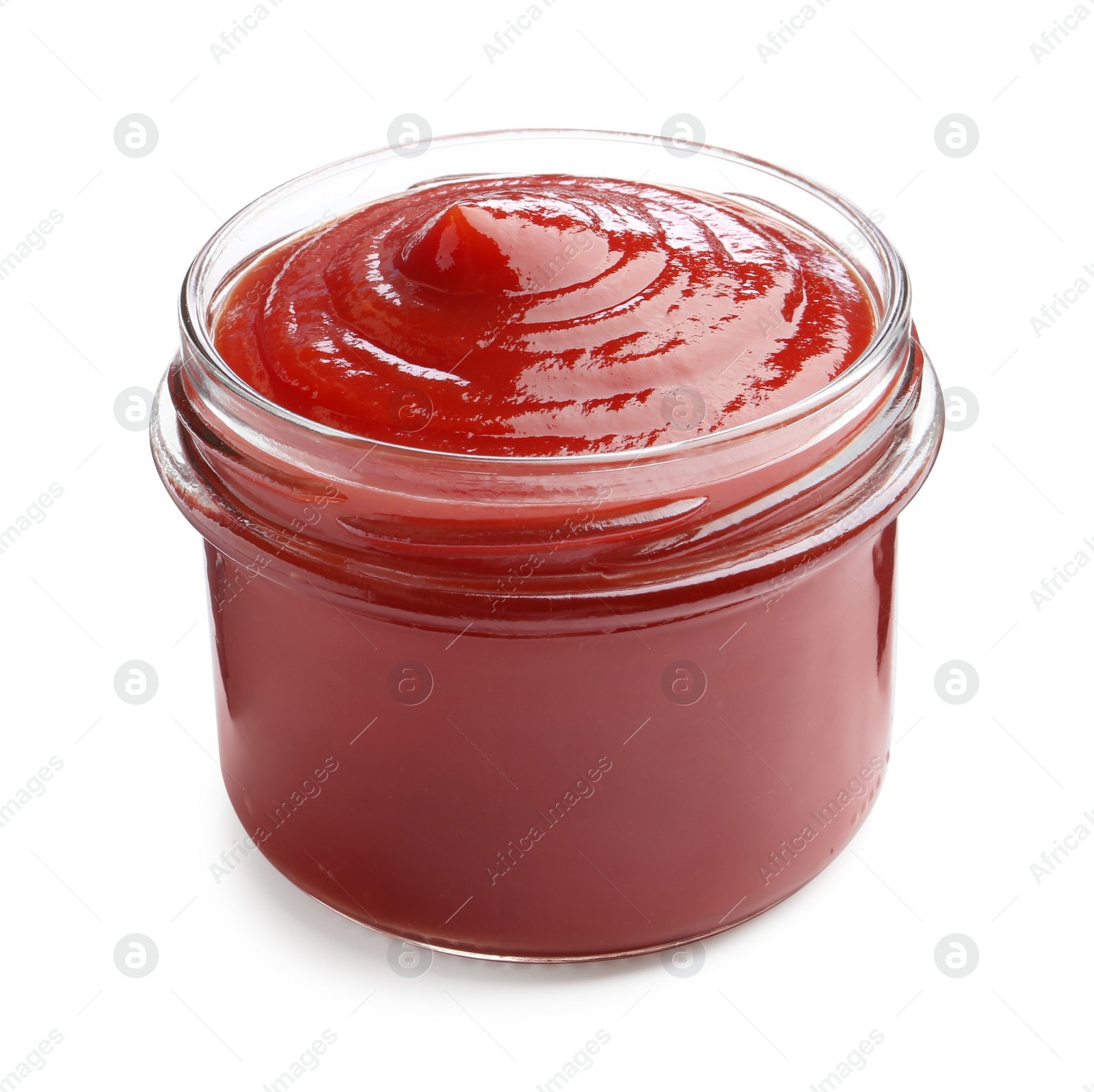 Photo of Tasty ketchup in glass jar isolated on white. Tomato sauce