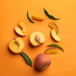 Photo of Flat lay composition with fresh peaches on orange background