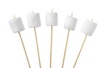 Sticks with delicious puffy marshmallows on white background
