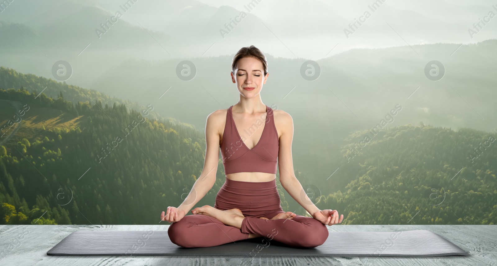 Image of Young woman practicing yoga on wooden surface against beautiful mountain landscape. Banner design