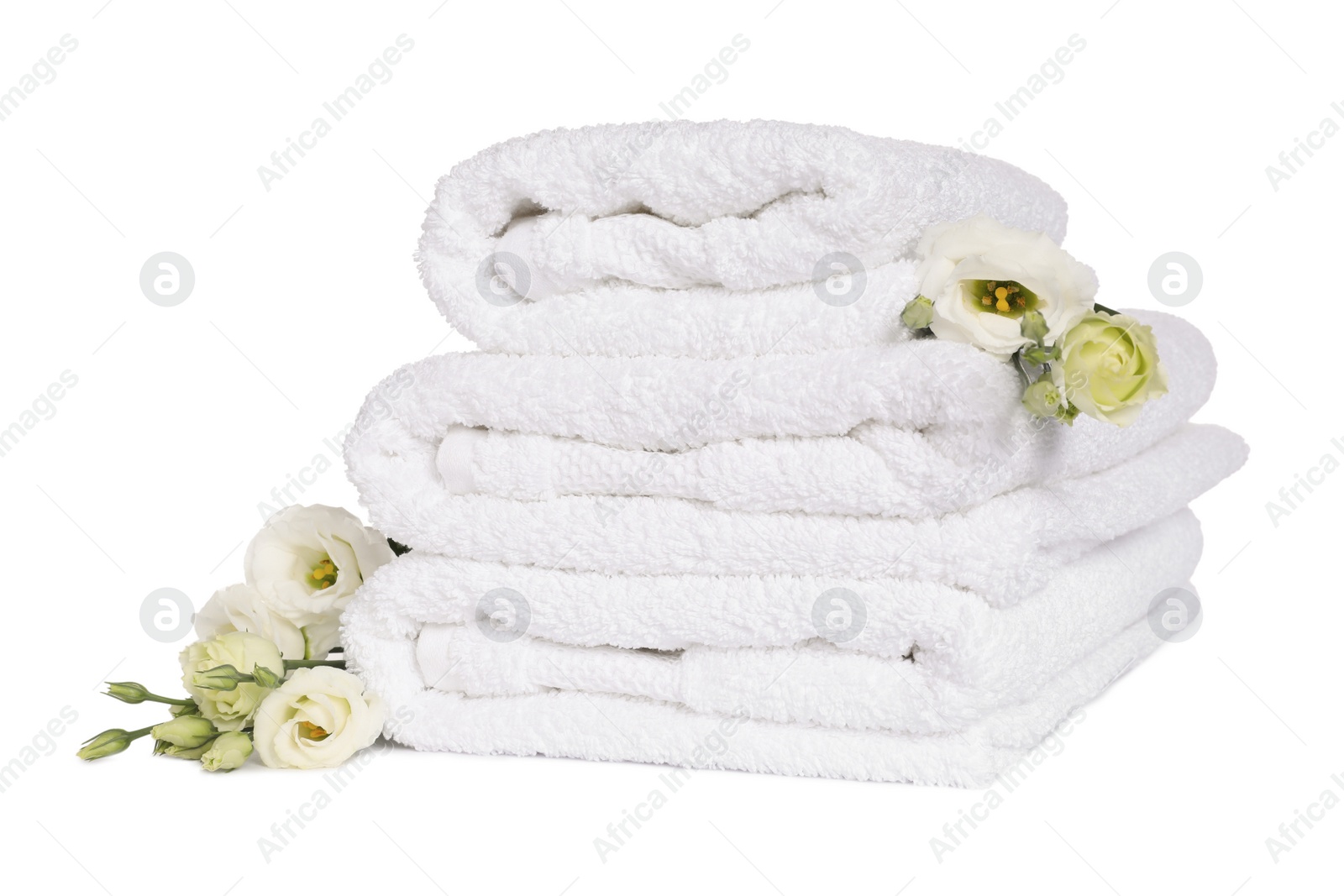 Photo of Stack of clean soft towels with flowers isolated on white