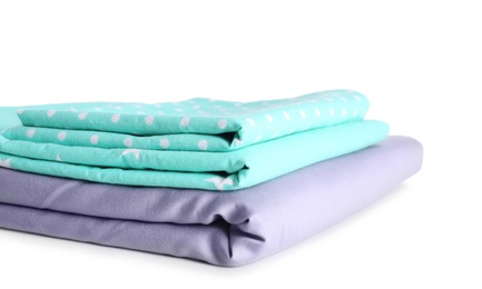 Stack of clean bed linen isolated on white