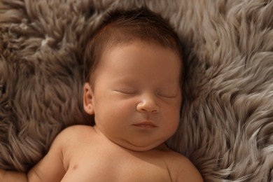 Photo of Cute newborn baby sleeping on fluffy blanket