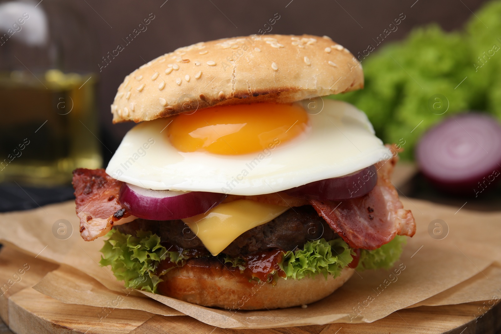 Photo of Delicious burger with fried egg on table, closeup