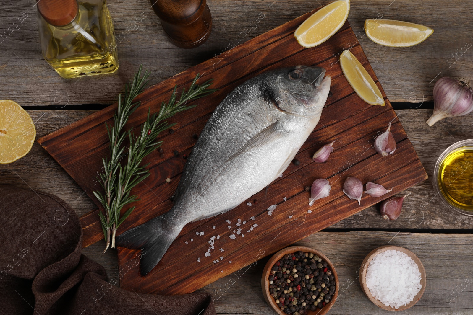 Photo of Flat lay composition with raw dorado fish and spices on wooden table